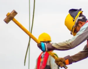 Worker with sledge hammer